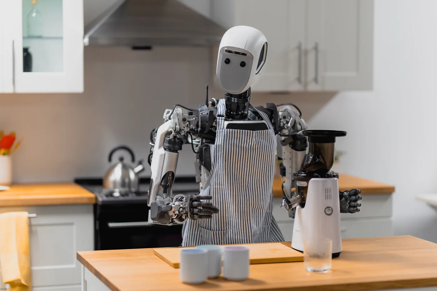 Humanoid robot working at a kitchen counter in a robotics lab